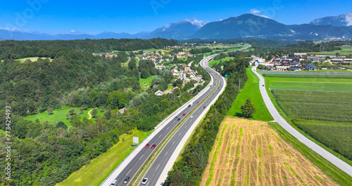 AERIAL: Drone point of view of commuters and tourists filling the rural highways
