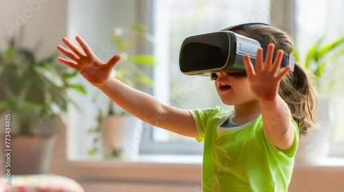 Excited young child exploring new worlds with virtual reality headset at home photo
