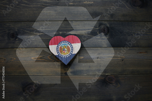Fototapeta wooden heart with national flag of missouri state near reduce, reuse and recycle sing on the wooden background
