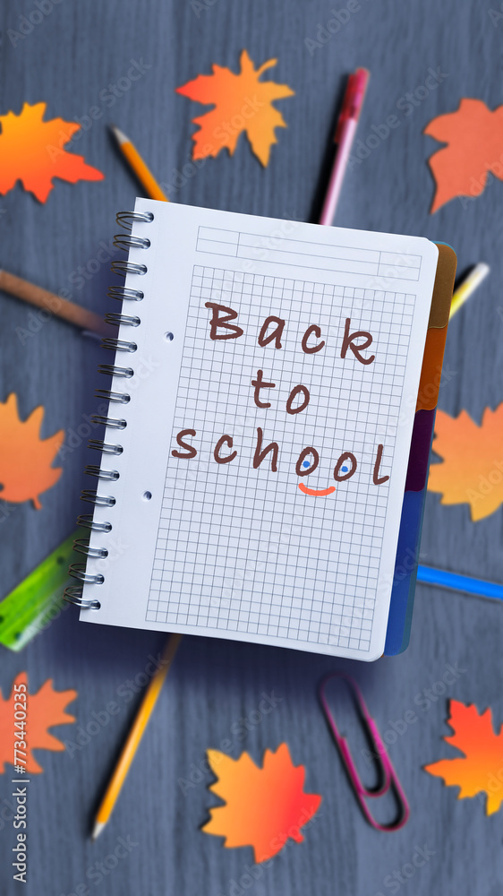 Back to school written on notepad. School slogan on blurred background ...