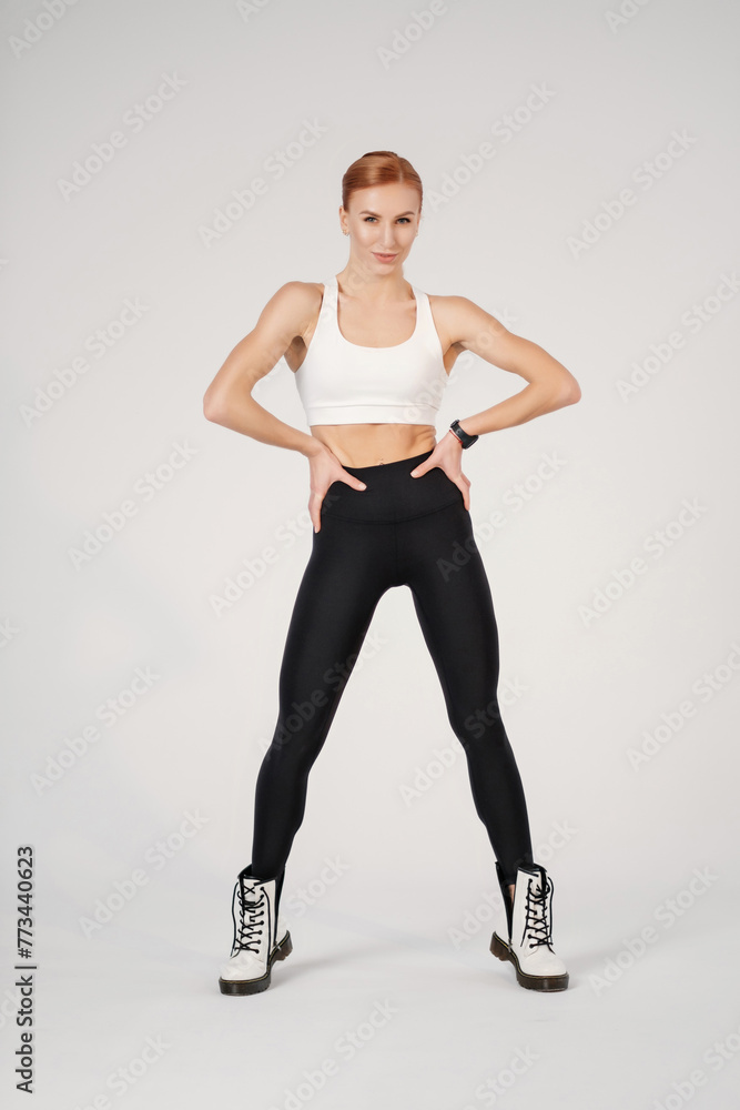 fit lady in sportswear and boots warming up before training fit lady in sportswear and boots warming up before training
