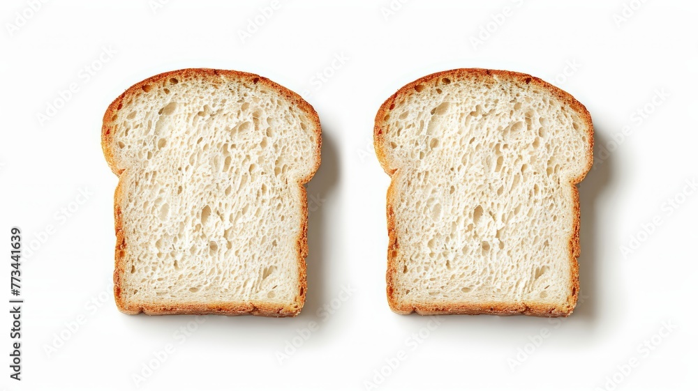 Two slices of white bread resting on a white surface