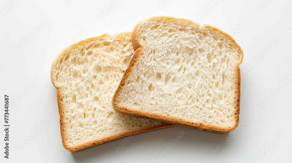 Two plain white bread slices arranged neatly on a clean white surface