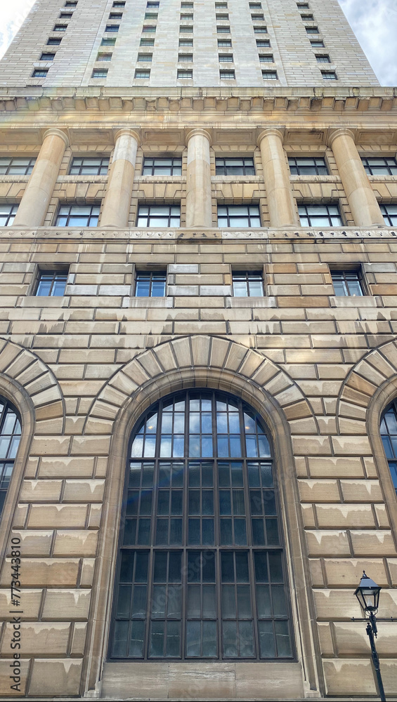 Fototapeta premium Windows of a building. Facade of an old stone skyscraper.