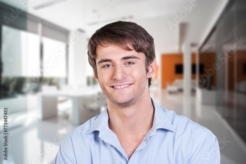 Happy handsome man posing in room
