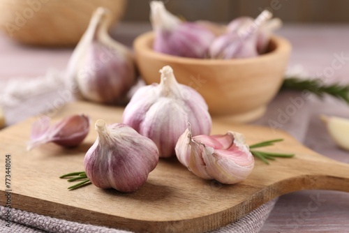 Tableau sur toile Bulbs and cloves of fresh garlic on table, closeup