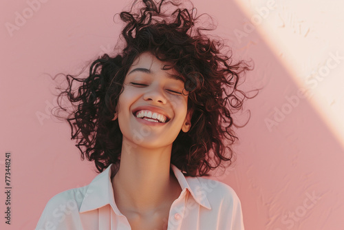 Joyful Young Woman with Curly Hair Enjoying Sunshine