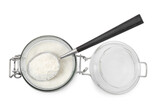 Baking powder in glass jar and spoon isolated on white, top view