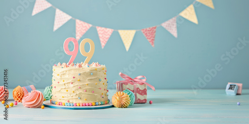 99th years birthday colorful cake with candles and birthday balloons, party pastel background. Space for text photo