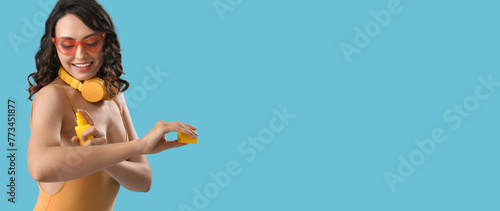 Young woman in swimsuit app...