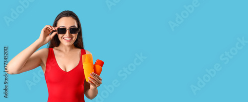 Young woman with bottles of...