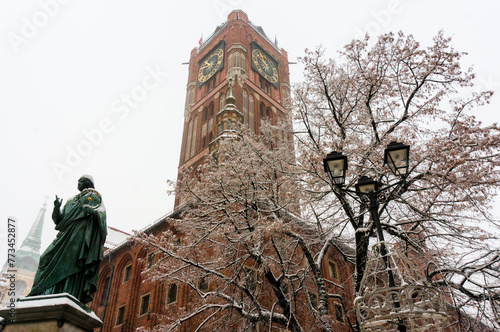 Winter in the City. Tower of Old Town Hall, Statue of great astronomer to Nicolaus Copernicus (Mikolaj Kopernik). December, 2021. Torun, Poland.