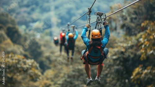 A group of friends enjoying a thrilling zip-line experience over a lush canopy.