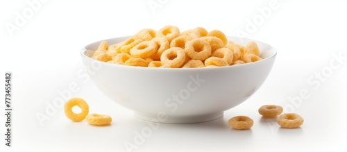 Crisp image showing a singular bowl containing a serving of cereal with a few circular rings immersed in it photo