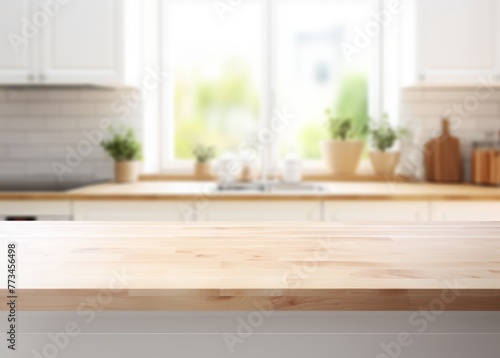 Empty wooden table top for product display montage  product mockup  focusing on the foreground with a defocused blur of a modern white and beige kitchen interior in soft natural light