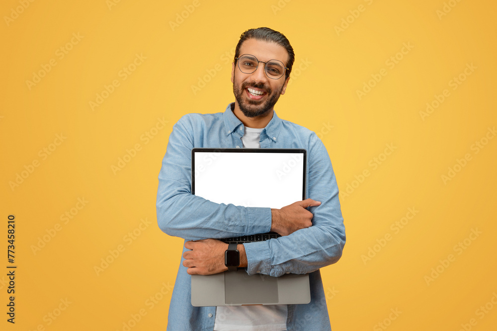 Man hugging laptop with blank screen Man hugging laptop with blank screen