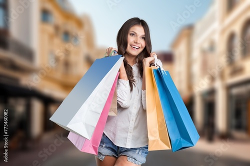 Cheerful young woman with shopping bags.