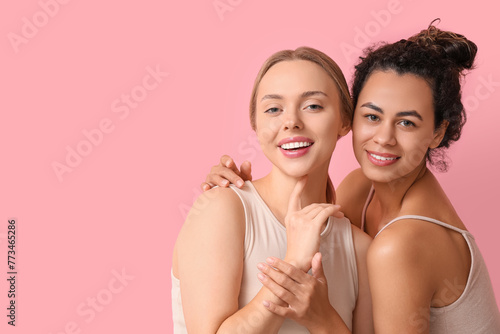 Happy young women on pink b...
