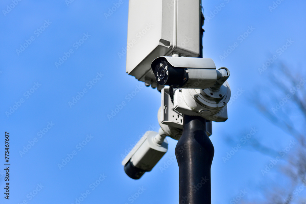 Street CCTV cameras on a pole against a blue sky