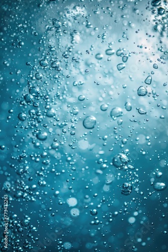 Close up shot of water bubbles on a blue background. Perfect for design projects