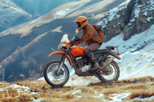 A man riding a motorcycle down a snow covered slope. Great for winter sports or adventure concepts © Fotograf