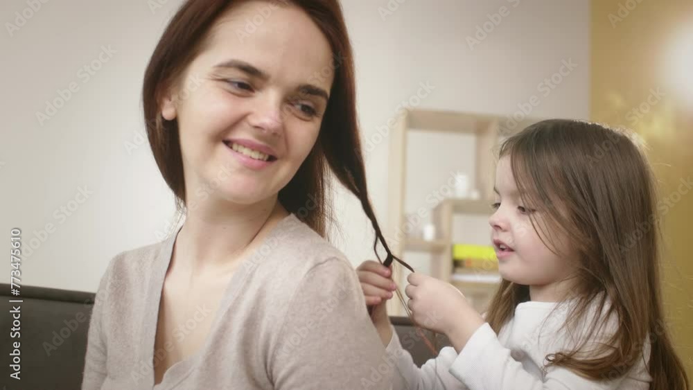 Mother and Daughter Sharing a Tender Moment Braiding Hair at Home Mother and Daughter Sharing a Tender Moment Braiding Hair at Home