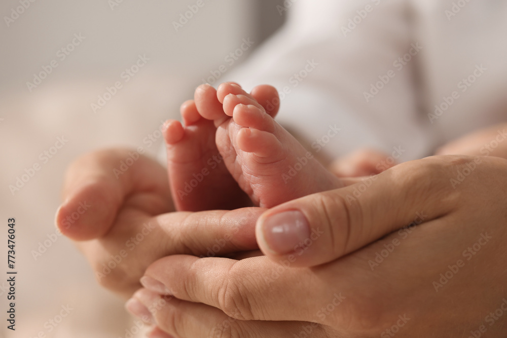 Mother holding her newborn baby, closeup view Mother holding her newborn baby, closeup view