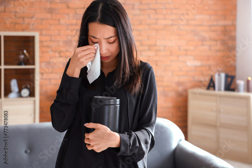 Grieving young Asian woman ...