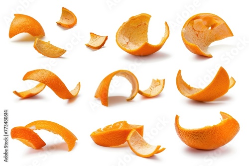 A collection of orange peels on a white surface. Ideal for food and nutrition concepts photo