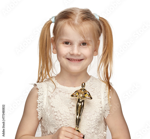 Blonde baby 6 years old, in a white dress shows a oscar