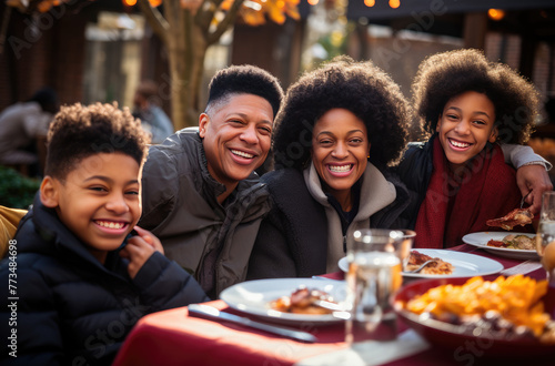 African black family  smiling  having a big happy thanksgiving feast saturday  dinner with an evening snack and foods in the style of bokeh  vibrant color  outdoor photo.