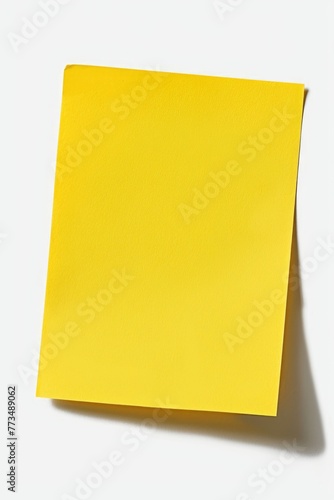 Yellow post it note on a plain white background. Suitable for office and business concepts