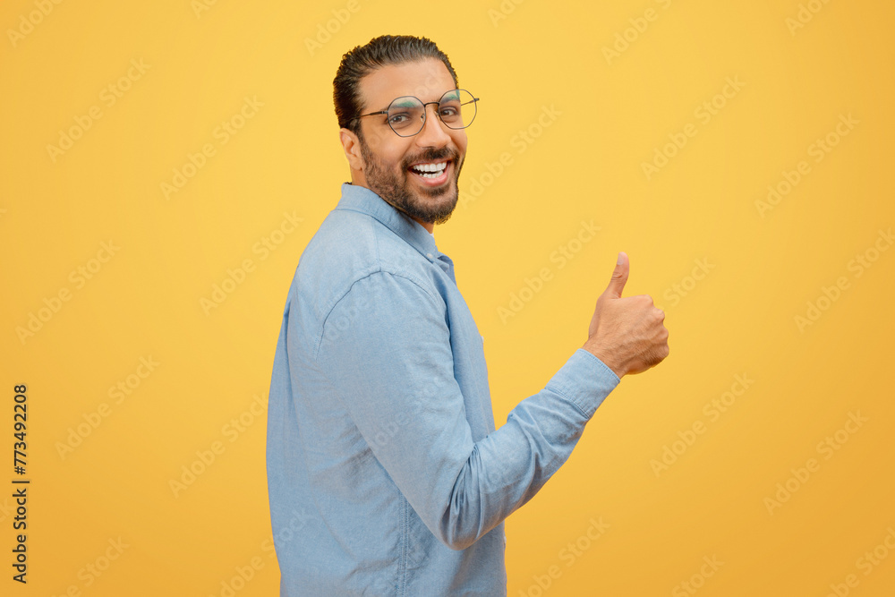 Man giving a thumbs up with a cheerful expression Man giving a thumbs up with a cheerful expression