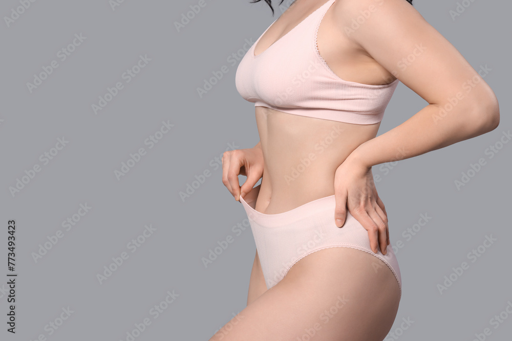 Beautiful young body positive woman in stylish underwear on grey background, closeup - obrazy, fototapety, plakaty 