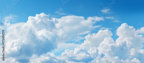 The sky is filled with numerous clouds hanging above the calm water surface