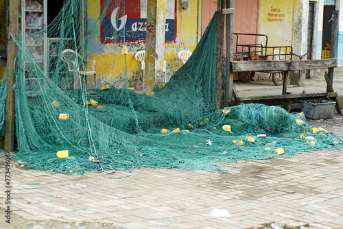 Fishing net hanging in front of a building in Limones, Esmereldas, Ecuador © Angela