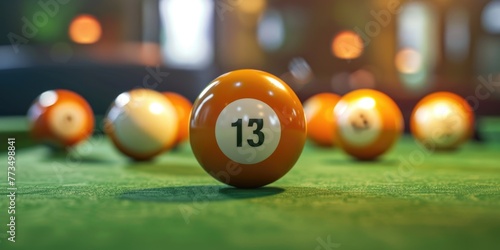 A pool ball sitting on a green table. Suitable for sports and leisure concepts photo