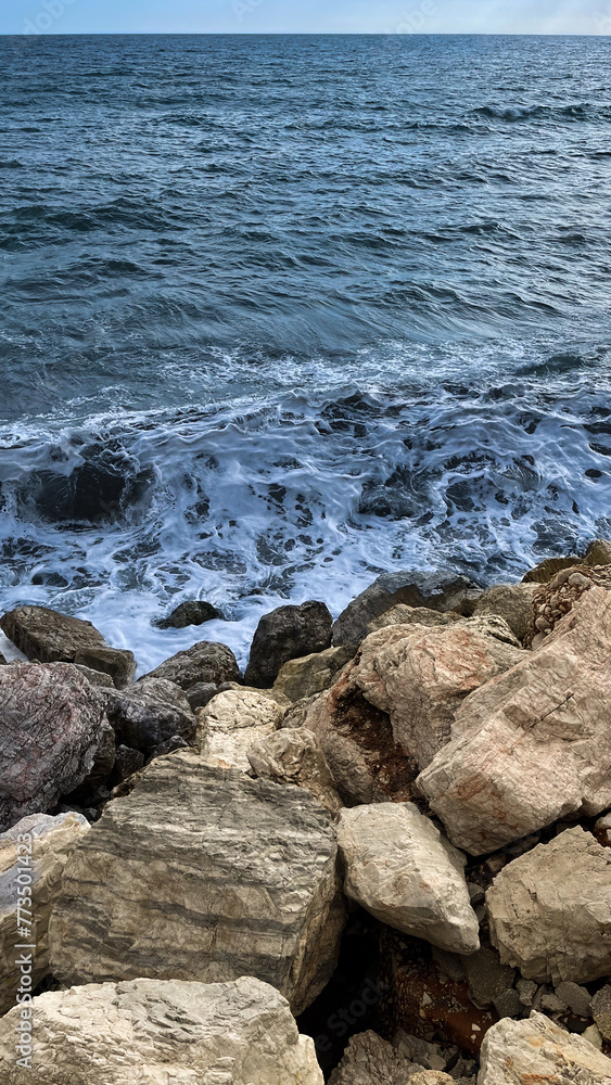 Fototapeta premium Waves crashing against the rocks of the coast of Malaga