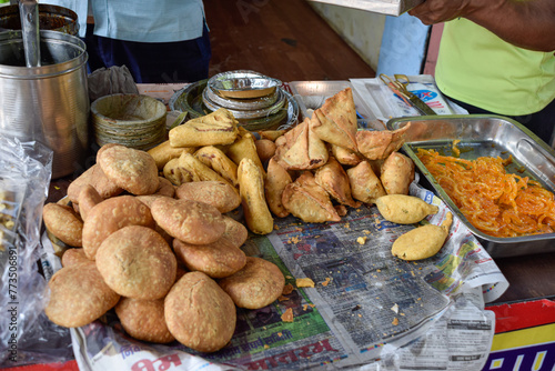 Traditional Namkeen Indian snacks and Samosas frying on street food and markets photo