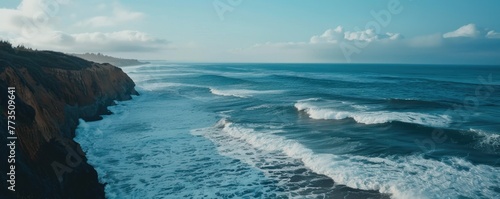 Panorama of the blue sea with waves washing the sand on the sea coast