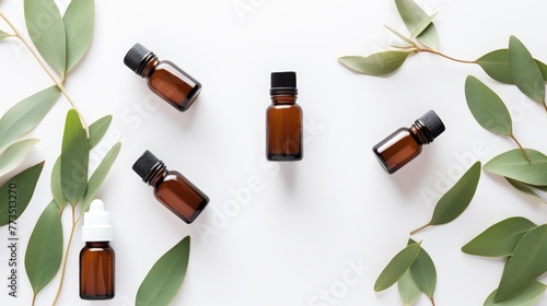 Display of essential oil bottles among scattered eucalyptus leaves