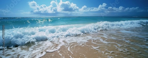 Panorama of the blue sea with waves washing the sand on the sea coast