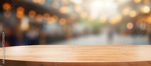 Wooden table surface with abstract blurred lights in the backdrop creating a warm and inviting atmosphere
