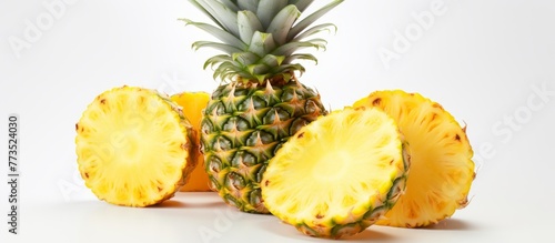 Three pieces of pineapples cut in half are displayed on a wooden surface, showing the vibrant yellow flesh and textured skin