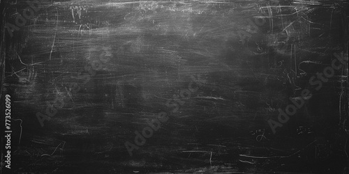 School blackboard texture. Black stone or slate textured background. Black chalk board texture background. Chalkboard, blackboard, school board surface with scratches and chalk traces. Wide banner. photo