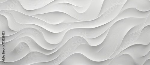 An intricate wave pattern is displayed on a close-up of a white wall, creating a visually appealing design