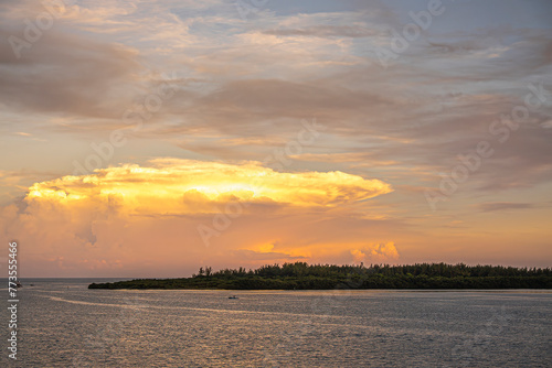 Miami, Florida, USA - July 29, 2023: Mushroom sunset cloud over north side Virginia Key island, forested green shoreline. 