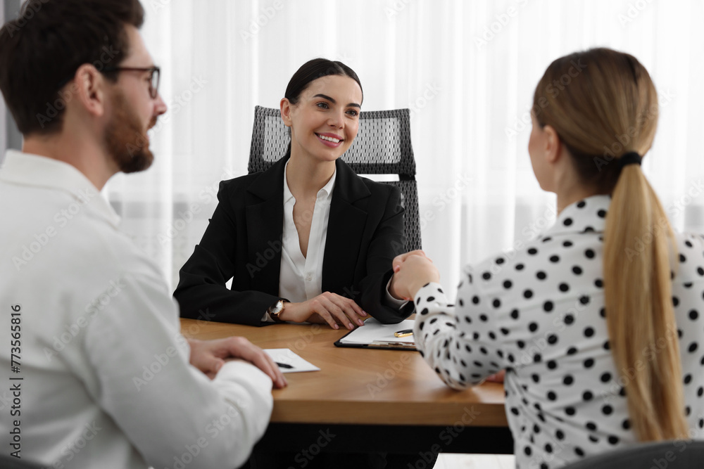 Lawyer shaking hands with clients in office Lawyer shaking hands with clients in office