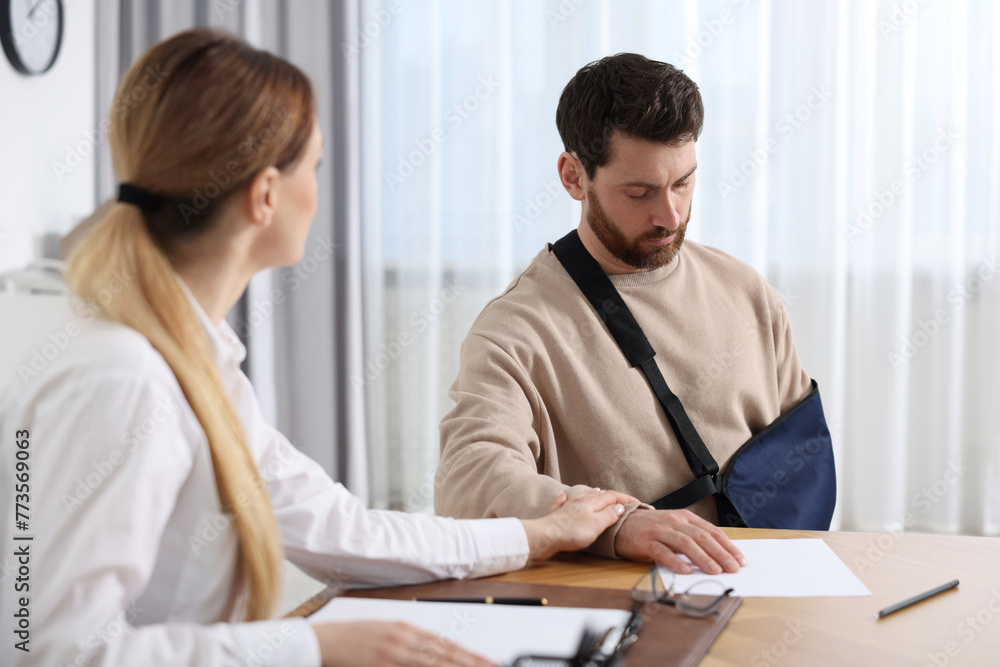 Injured woman having meeting with lawyer in office Injured woman having meeting with lawyer in office