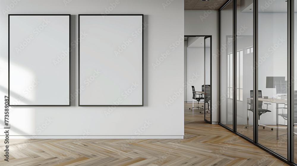 mockup of two blank posters on a wall in an office with glass doors, wooden floors, white walls, and ceiling lights.